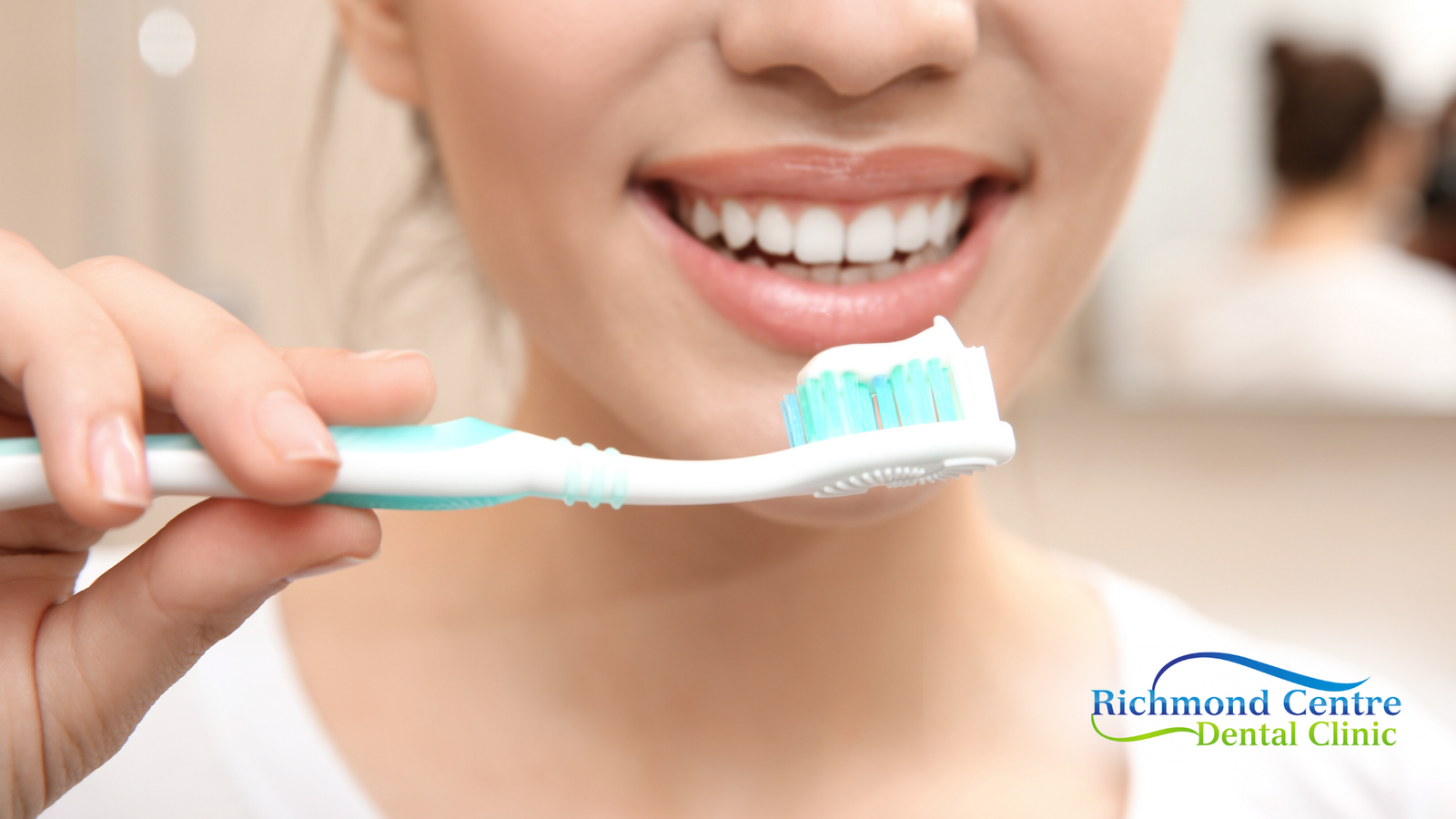 A woman is brushing her teeth with a toothbrush.